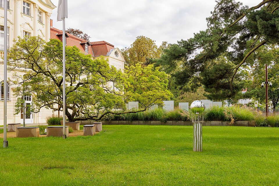 Skulptur ‚100 Jahre JRK‘ Wiese mit Metallskulptur