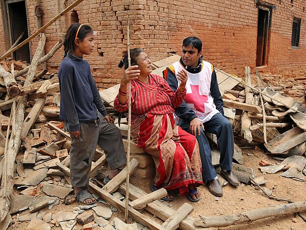 Volunteer, woman and girl in debris