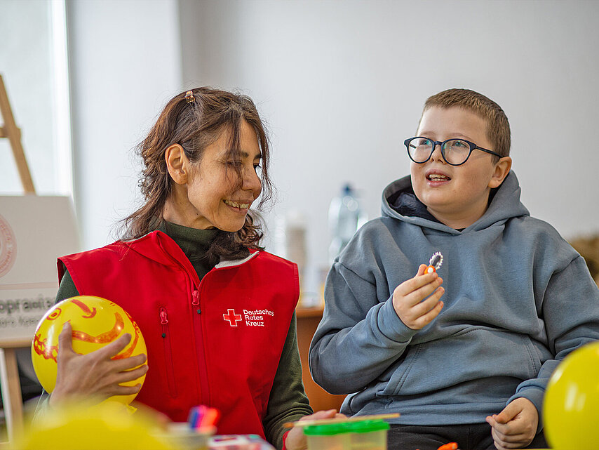 Volunteer interacting with boy